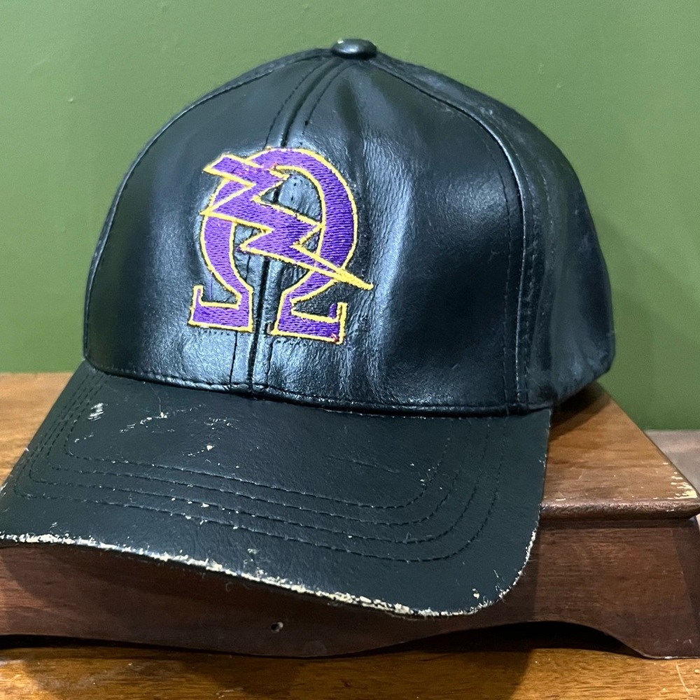 Omega Black Leather Cap with Purple and Yellow Logo